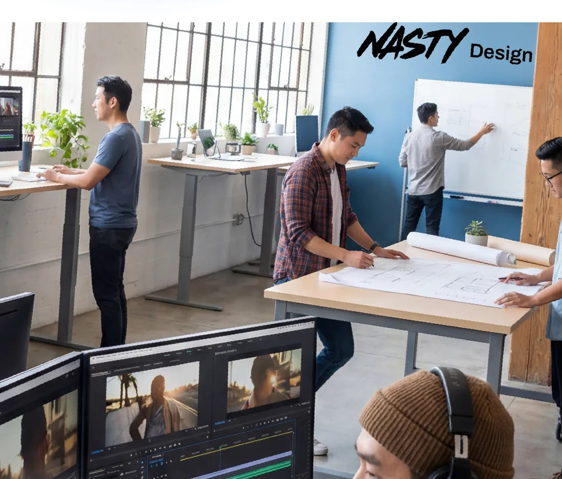 The Kuala Lumpur studio at work, drawings spread across the table and an edit bay in the foreground.