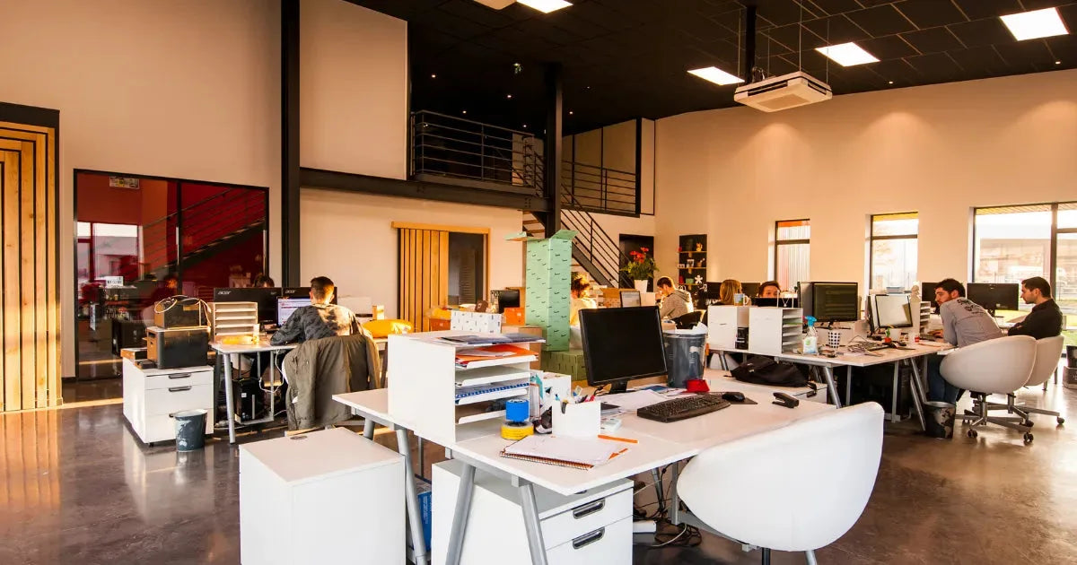 The Kuala Lumpur design team together between the desks, most of the studio in one frame.